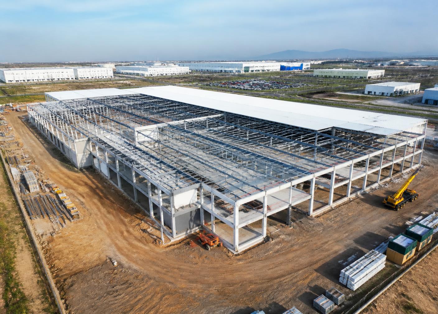 Holographic building models rising over a solar-powered construction site